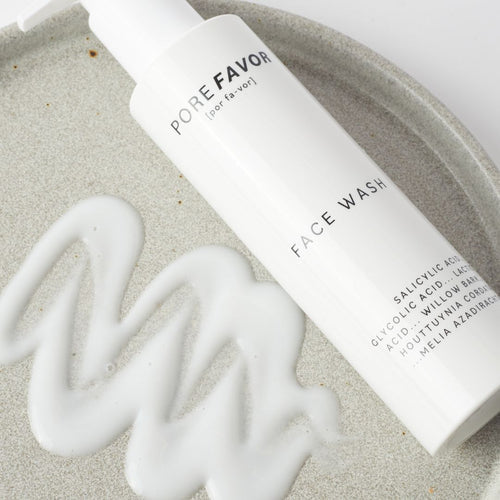 AHA vs BHA Face Wash lying on a stone plate